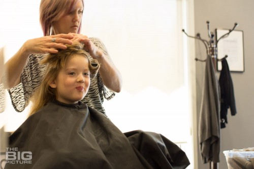 children's portraits photography, girl getting her hair done at a salon for the first time