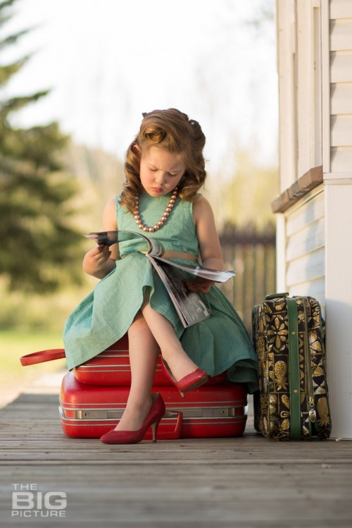 childrens photography, little girl at the train station in high heels reading a magazine, vintage hair, retro kids photos