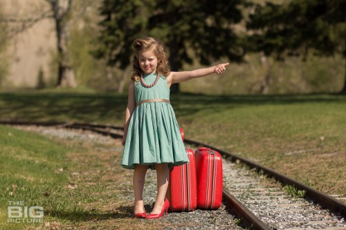 children's photography, young girl in high heels and victory rolls hitchhiking at railroad tracks, children's pictures railroad tracks, runaway