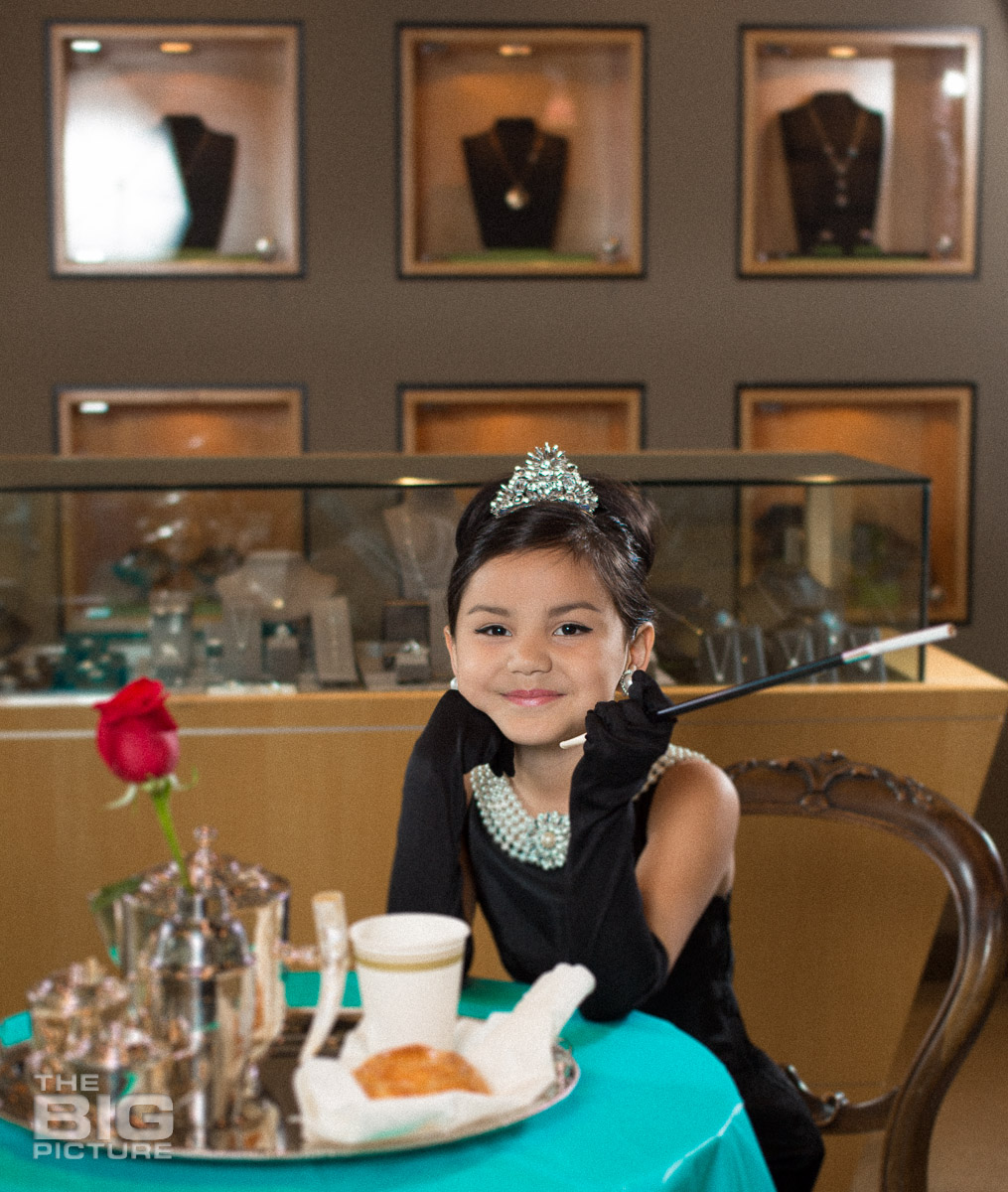 Children's Photography - Kids Photography - Ava sitting at the table in a jewellery shop