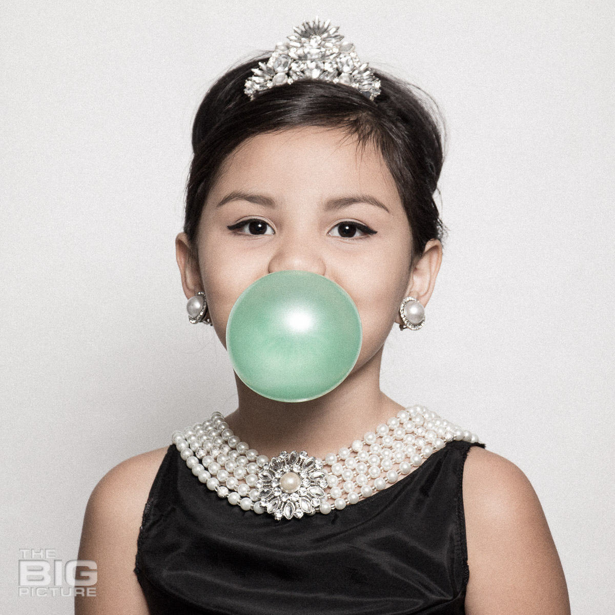 Ava blowing a bubble like Audrey Hepburn in a scene from breakfast at Tiffany's  - kids photography - children's photography
