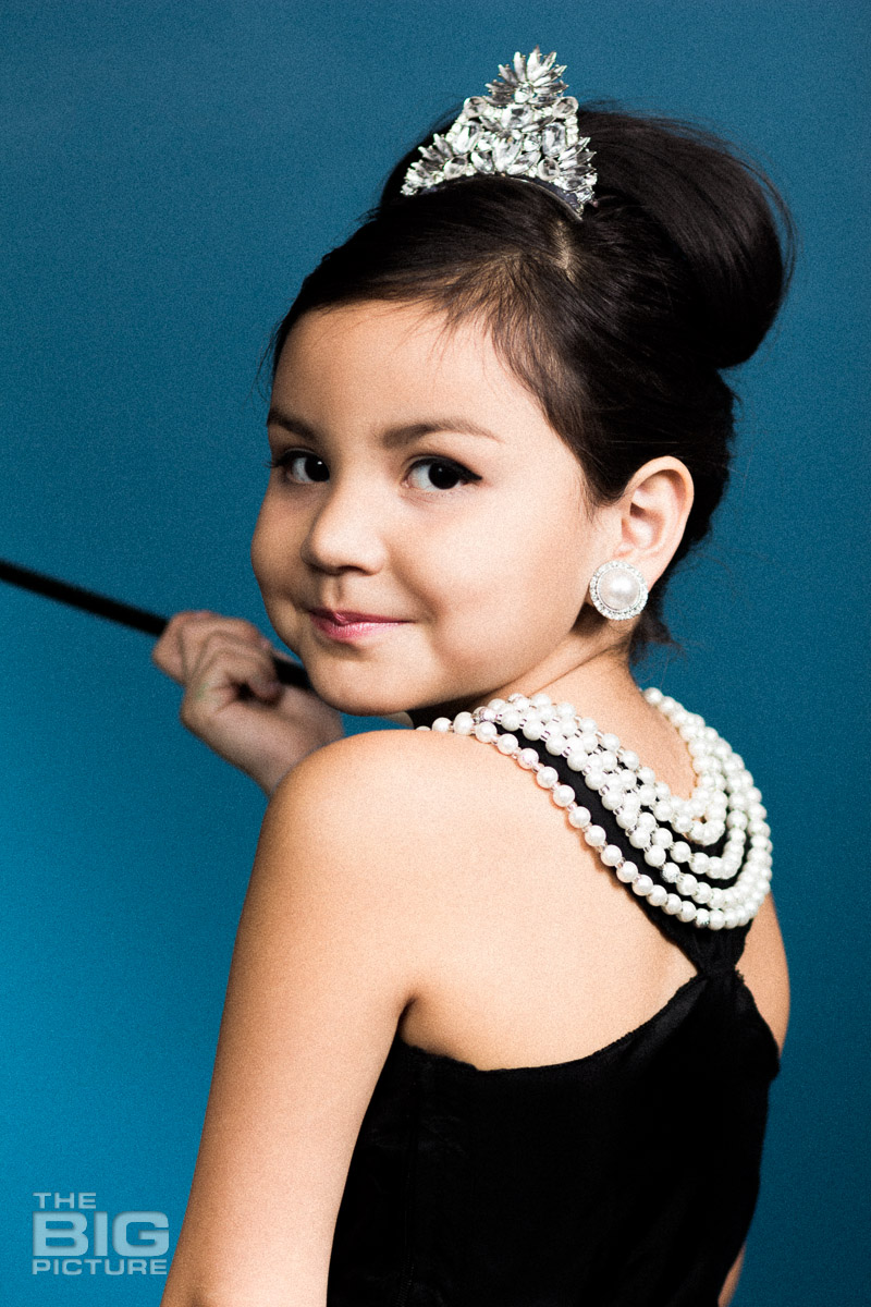 Ava dressed up like Audrey Hepburn in a scene from breakfast at Tiffany's - wearing pearls and a tiara  - kids photography - children's photography